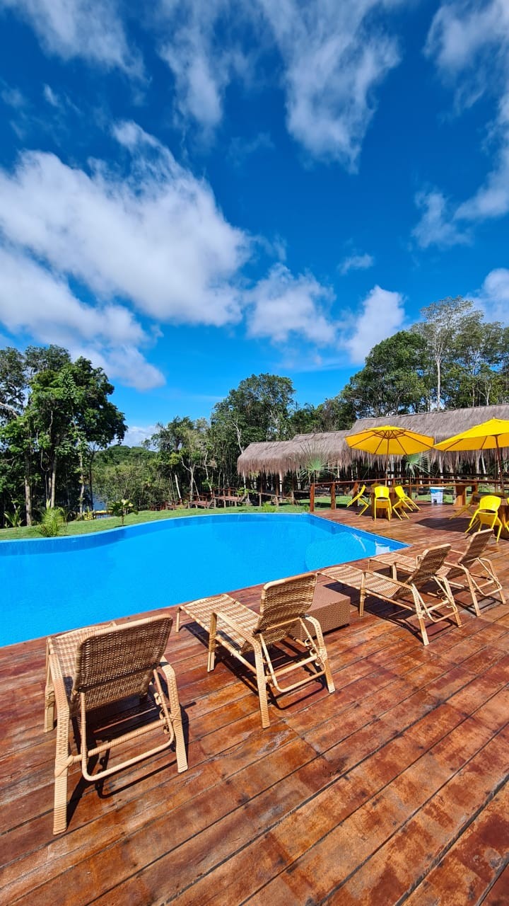 view of the amazon xplor lodge with the pool in the foreground